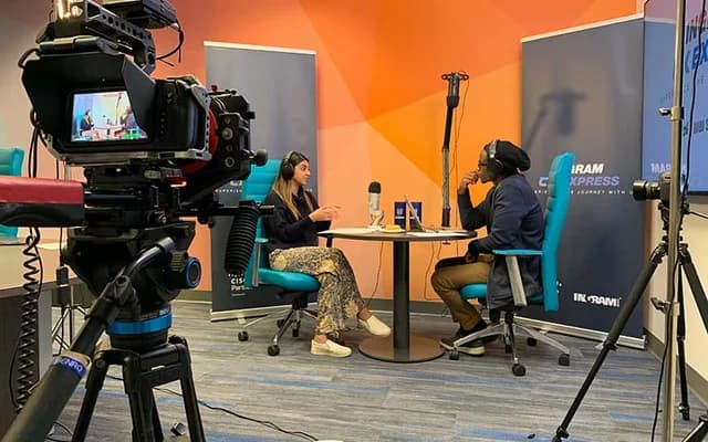 Corporate interview and podcast production with cameras, microphones, and lighting