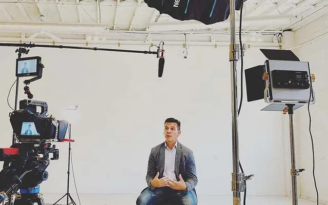 Professional interview setup with camera, boom microphone, and controlled lighting